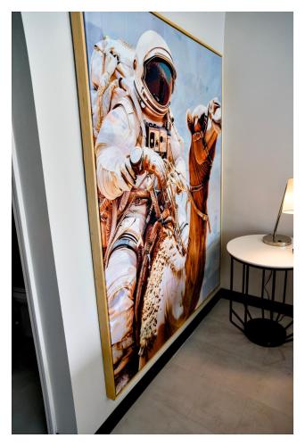 a painting of an astronaut on the wall at Heights House Hotel - Houston Heights Downtown, an Ascend Collection Hotel in Houston