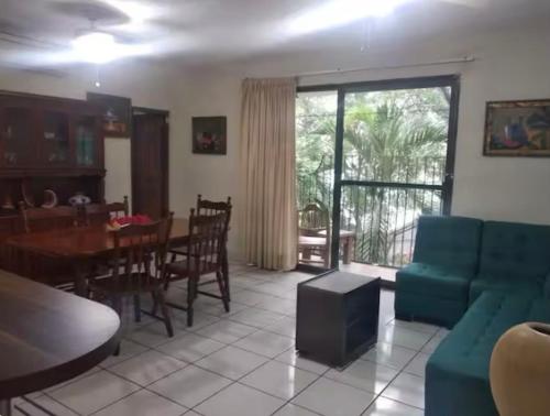 a living room with a blue couch and a table at Cozy Marbella suits 2 bed 2 bath in Puerto Vallarta