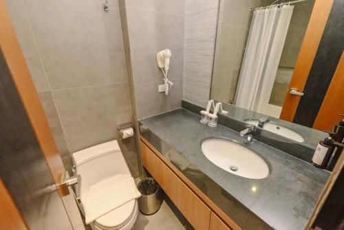 a small bathroom with a sink and a toilet at Sotogrande Hotel and Convention Center Batangas in Bauan
