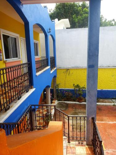 un edificio blu e giallo con balconi di Hotel San Pedro habitacion sencilla a Villahermosa