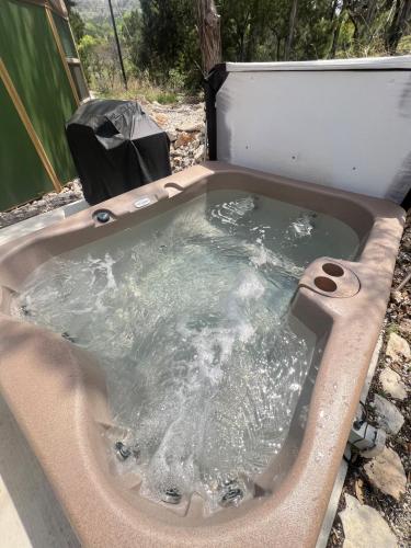 a jacuzzi bathtub with water in it at Beaumont Hill Country Luxury Yurt Cabin w Hot Tub in Canyon Lake