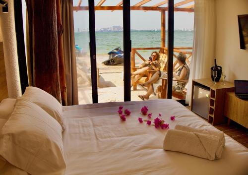 a bedroom with a bed with flowers on it at Marazao Beach Hotel & Spa in Tierra Bomba