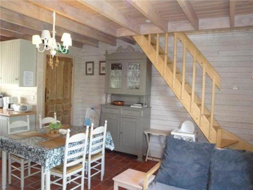 a kitchen and dining room with a table and a staircase at Jardin de Lieze in Maldegem