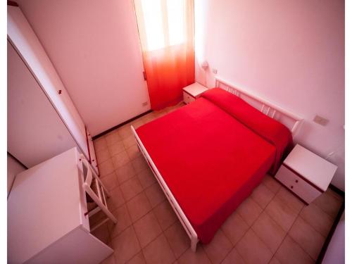 a small red bed in a small room with stairs at Appartement in Luni mit Pool in Luni