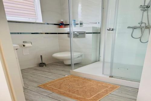 a bathroom with a toilet and a glass shower at Studio in Mi dzywodzie near Baltic Beaches in Międzywodzie