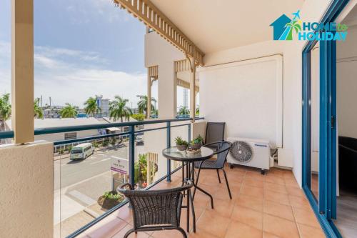 a balcony with a table and chairs and a view of a street at Marina View Studio - Steps away from CBD, Ferry & Stadium in Townsville