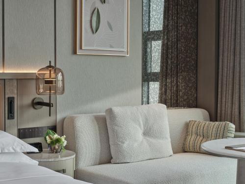a hotel room with a chair and a bed at Doubletree By Hilton Yanji in Yanji