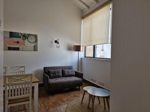 a living room with a couch and a table at River View Ferragudo Terrace Villa in Ferragudo