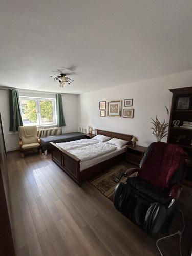 a bedroom with a bed and a chair at Halka Apartment 3 in Rabčice