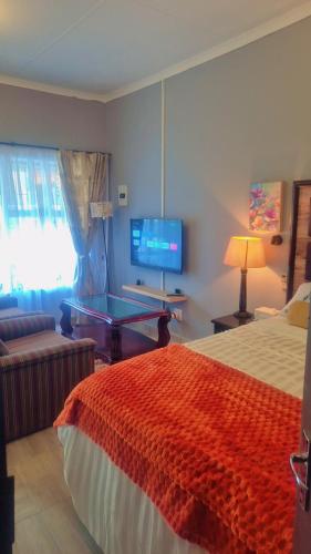a bedroom with a bed and a ping pong table at Little Haven! in Rustenburg