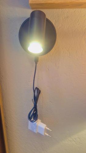 a light attached to a wall with a cord plugged into it at Little Haven! in Rustenburg