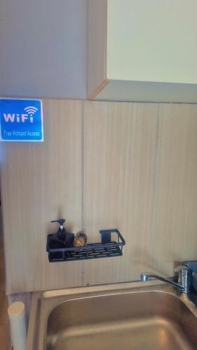 a sign on a wall above a sink at Little Haven! in Rustenburg