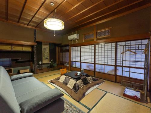 a living room with a couch and a table at Ryouriryokan Asahikan in Shionoha