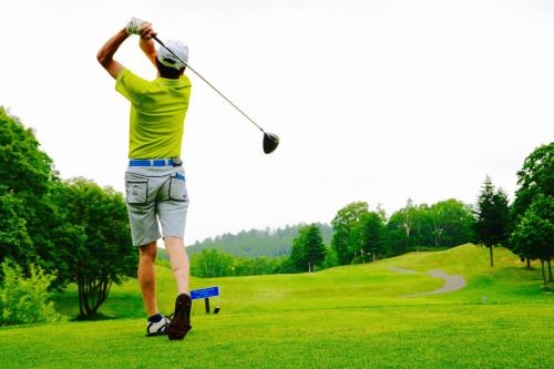un uomo che fa oscillare una mazza da golf su un campo da golf di Hinzan a Kutchan