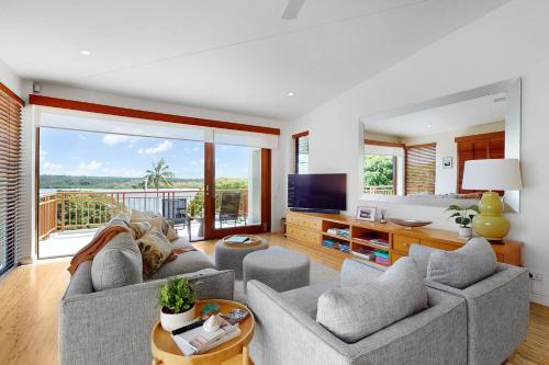 a living room with a couch and a tv at Penthouse at Colonial in Noosaville