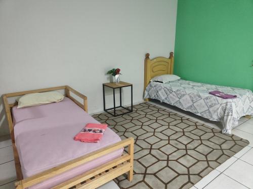 Postel nebo postele na pokoji v ubytování Hostel Caetano