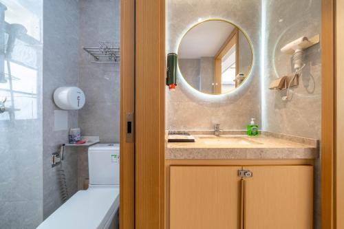 a bathroom with a sink and a mirror at Dreamscape Retreat Three-bedroom suite near Atlantis Hotel Sanya in Sanya