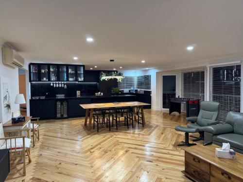 a kitchen and living room with a table and chairs at Seaside Serenity in Mount Martha