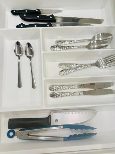 a drawer with silver utensils in it at Modern City Living with the Harbour Views in Wellington