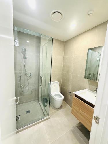 a bathroom with a shower and a toilet and a sink at Modern City Living with the Harbour Views in Wellington