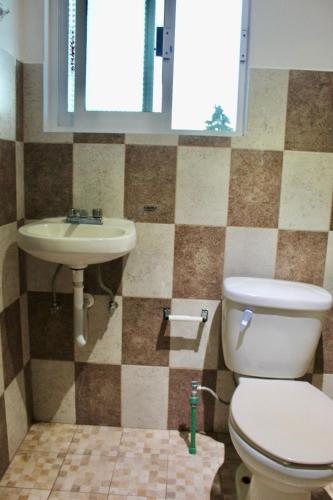 a bathroom with a toilet and a sink at Apartment, Star Hotel in Zacatlán