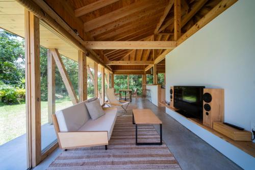 a living room of a house with a couch and a table at SHINMINKA Villa GUSHIKEN in Motobu