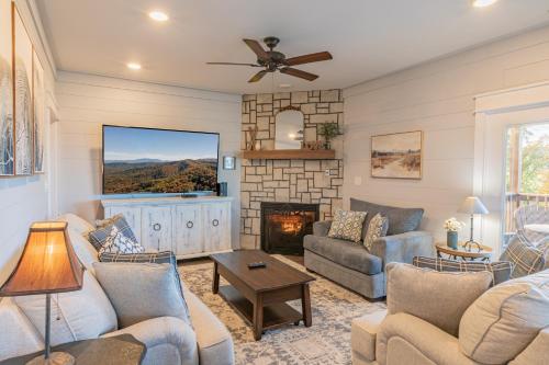 a living room with a couch and a fireplace at Red Roof Chalet of the Smokies in Gatlinburg