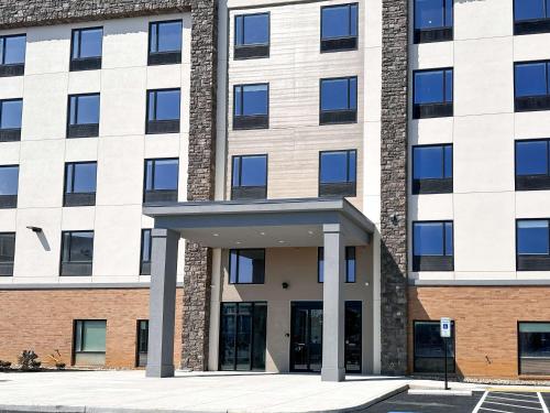 a large brick building with a large entrance at Studio 6 Richmond-Airport in Sandston
