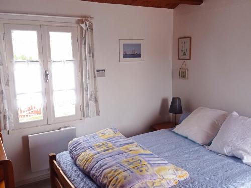 une chambre avec un lit et une fenêtre dans l'établissement Maison proche plage, 3 pers, animaux admis - FR-1-823-128, à Noirmoutier-en-l'lle