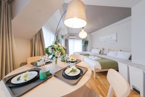 a room with a bed and a dining table in a room at Solana Roppongi in Tokyo