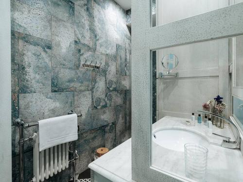 a bathroom with a sink and a bath tub at Appartement historique, animaux admis, centre de Pézenas - FR-1-607-213 in Pézenas