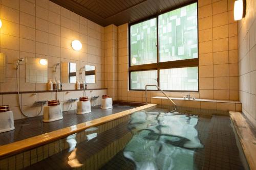 a bathroom with a swimming pool and a large window at Wan's Resort Yamanakako in Yamanakako