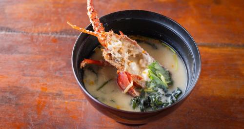 a bowl of soup with a piece of food in it at Hotel SEASONS NICHINAN in Nichinan