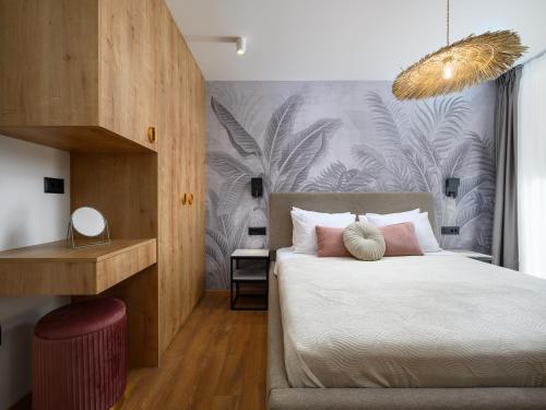 a bedroom with a bed with white sheets and pink pillows at Room in Porec Old Town by Waterfront in Poreč