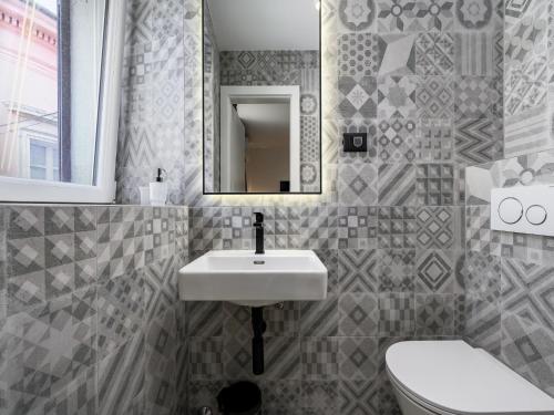 a bathroom with a sink and a toilet and a mirror at Room in Porec Old Town by Waterfront in Poreč