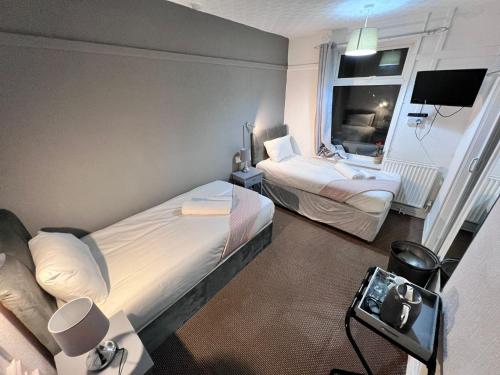 a hotel room with two beds and a window at Harbour Hotel in Skegness