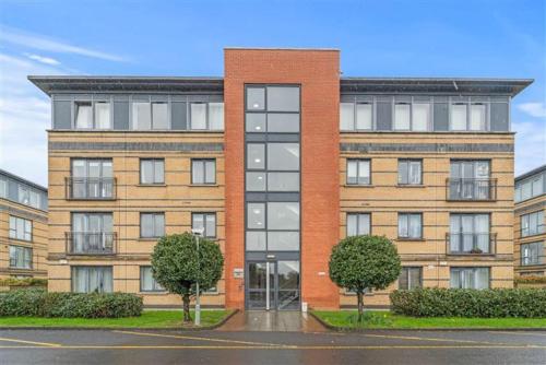 a large brick building with trees in front of it at Cheap modern room in Dublin