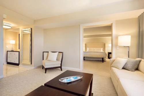 a living room with a couch and a bed at The H Hotel in Midland