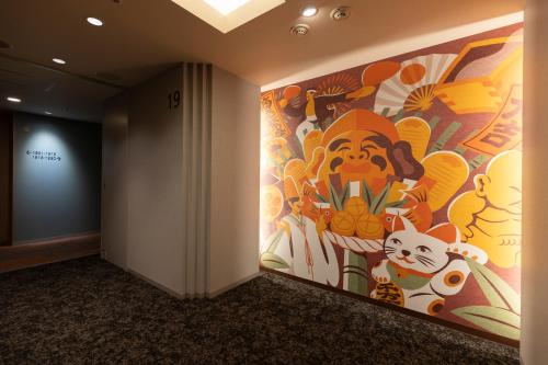 a hallway with a painting on the wall at Hiyori Hotel Osaka Suminoekoen Station in Osaka