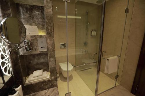a bathroom with a glass shower with a toilet at Crowne Plaza New Delhi Rohini by IHG in New Delhi