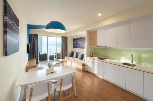 a kitchen and living room with a table and chairs at TUI BLUE Nha Trang in Nha Trang