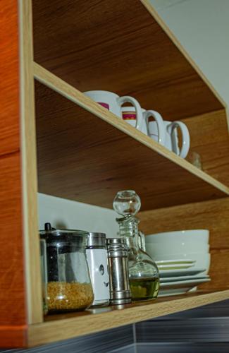 a shelf with dishes and other items on it at "CASITA AZUL"- Apartamento con bonita vista Volcan in Chivay
