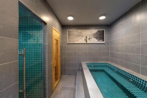 a bathroom with a swimming pool and a shower at TUI BLUE Nha Trang in Nha Trang