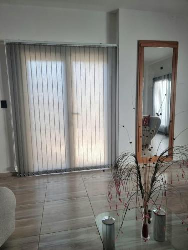 a living room with a large window and a mirror at La casa de Flor in San Martín