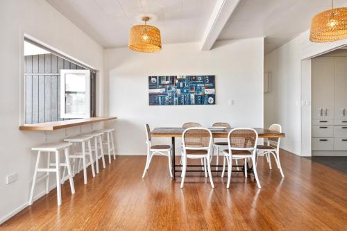 a dining room with a table and chairs at Coastal Vista - Ngunguru Holiday Home in Ngunguru