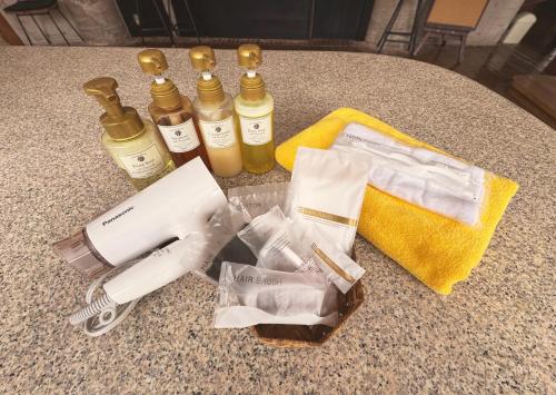 a table with four bottles of oils and a hair dryer at the Kinta Naeba in Yuzawa