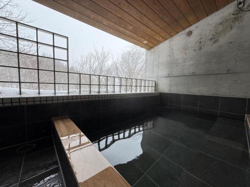 a room with a pool of water in a building at the Kinta Naeba in Yuzawa
