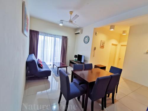 a living room with a dining room table and chairs at Nature Home - Swiss Garden Resort Residences in Kuantan