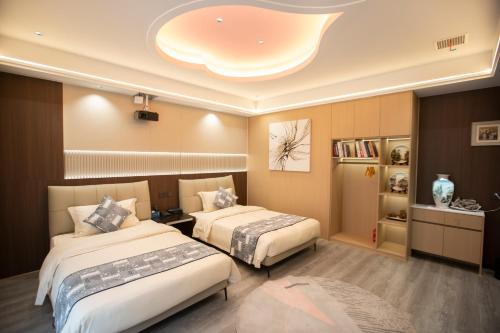 a hotel room with two beds and a room with at Xingfu Farm Resort in Zhangjiajie