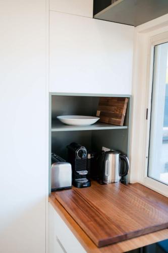 a kitchen with a microwave and a coffee maker on a counter at The Boat House Central Location in Goolwa